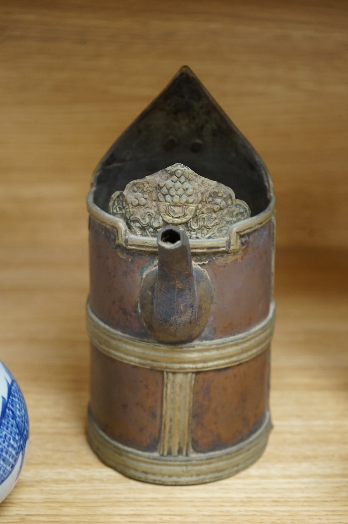 A Chinese blue and white bottle vase, a crackle glaze vase and a Tibetan copper and brass ‘monk’ cap’ ewer (3), tallest 21cm